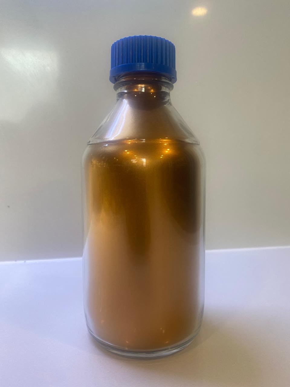 Sample bottle of stabilized copper nanoparticle colloid produced for particle-size analysis